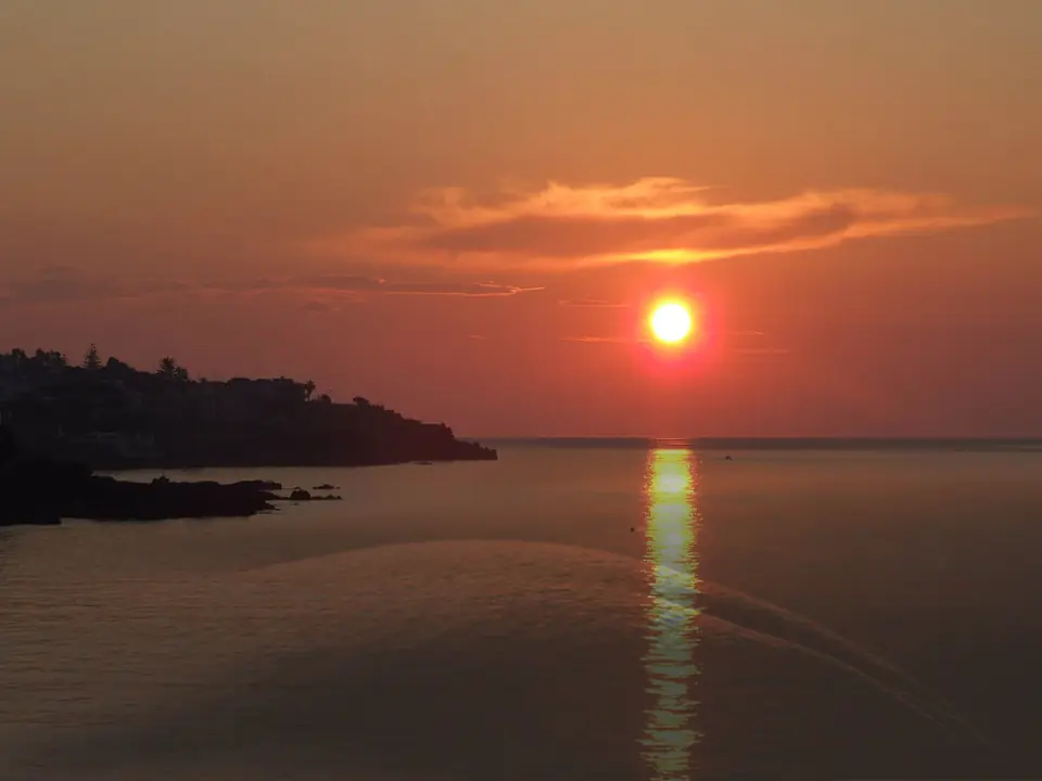 Lågt solljus över havet vid Ognina i Catania.